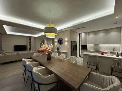a living room with a large wooden table and chairs at Exclusive villa Kaza - Przno in Budva