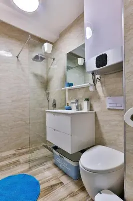 a bathroom with a toilet and a sink and a shower at Sunny Studio in Bečići in Budva