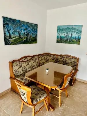 a living room with a table and a couch at Guest House Djakonovic in Ulcinj