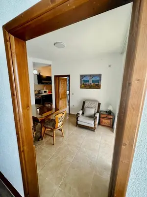a living room with a table and a chair at Guest House Djakonovic in Ulcinj