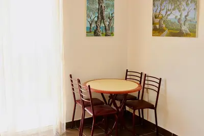 a table and chairs in a corner of a room at Guest House Djakonovic in Ulcinj