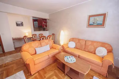 a living room with two couches and a table at Anika apartment in Podgorica