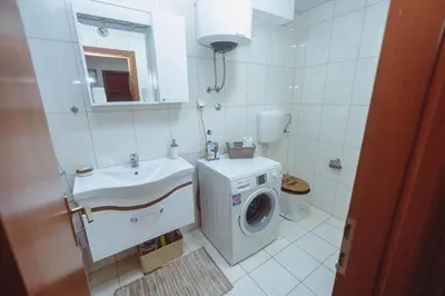a bathroom with a washing machine and a sink at Anika apartment in Podgorica