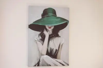 a painting of a woman wearing a green hat at Anika apartment in Podgorica