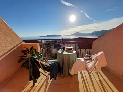 a balcony with a table and chairs on a balcony at Apartmani Dalex in Budva