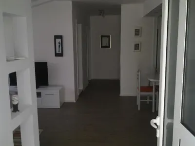 a hallway of a room with white walls and a table at Mediteraneo Apartments in Budva