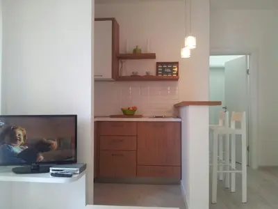a living room with a tv and a kitchen at Mediteraneo Apartments in Budva