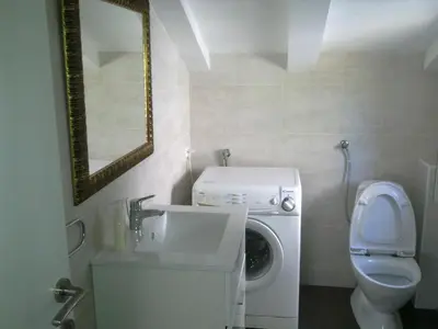 a bathroom with a sink and a washing machine at Mediteraneo Apartments in Budva