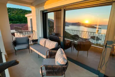 a balcony with chairs and a view of the ocean at Magic view - Apartment with Pool in Budva