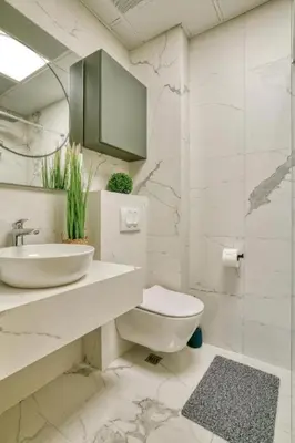 a white bathroom with a sink and a toilet at Magic view - Apartment with Pool in Budva