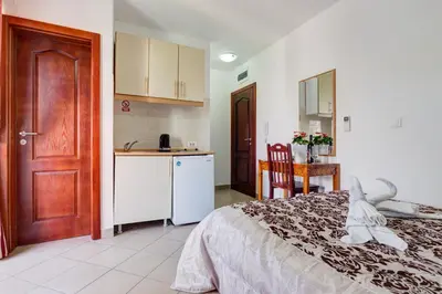 a kitchen and a bedroom with a bed and a table at Villa Jadranka Sutomore in Sutomore