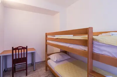 a room with two bunk beds and a desk at Villa Jadranka Sutomore in Sutomore