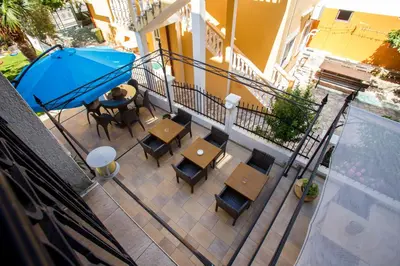an overhead view of a balcony with tables and an umbrella at Villa Jadranka Sutomore in Sutomore