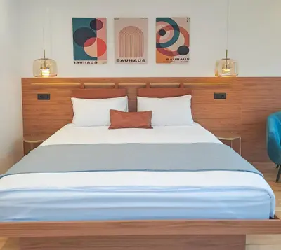 a bedroom with a large bed with two pillows at Stylish Apartment with Elegant Touches in Podgorica