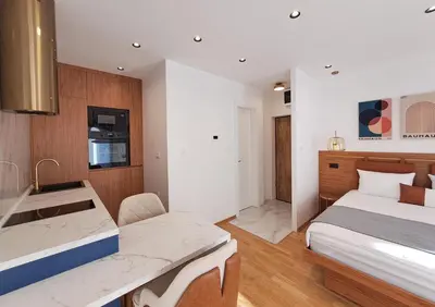 a bedroom with two beds and a sink in it at Stylish Apartment with Elegant Touches in Podgorica