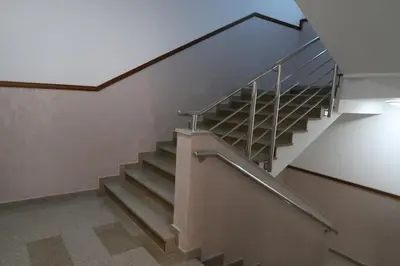 a staircase in a building with a metal railing at Apartmani LUX Becici in Becici