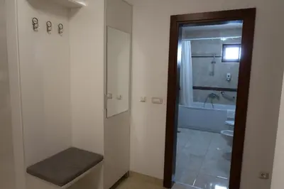 a bathroom with a toilet and a sink and a tub at Apartmani LUX Becici in Becici