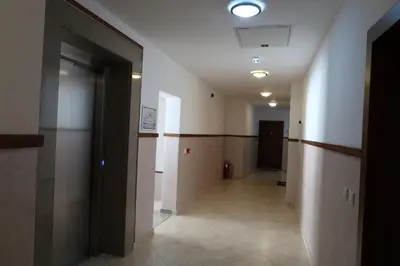 a hallway of a building with a door and a basketball hoop at Apartmani LUX Becici in Becici