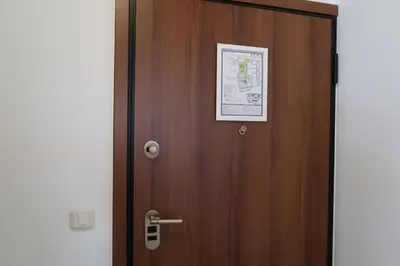 a wooden door with a picture on it at Apartmani LUX Becici in Becici