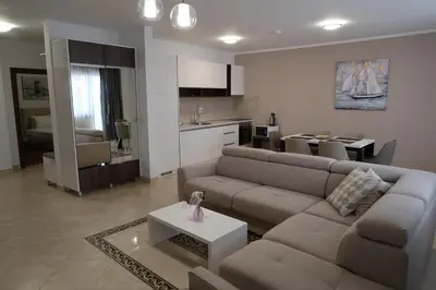 a living room with a couch and a table at Apartmani LUX Becici in Becici