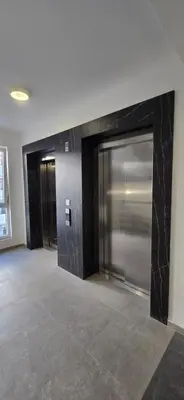a lobby with a large glass door in a building at Zoya Apartment in Podgorica