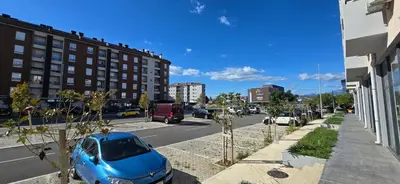 a blue car parked on the side of a city street at Zoya Apartment in Podgorica