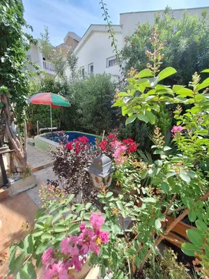 a garden with flowers and a swimming pool at Apartment at villa with pool in Budva