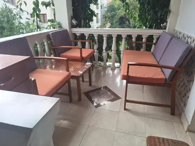 a group of chairs sitting on a balcony at Apartment at villa with pool in Budva