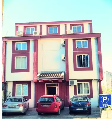 a building with three cars parked in front of it at Explorer Podgorica in Podgorica