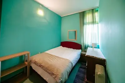 a small room with a bed and a window at Explorer Podgorica in Podgorica