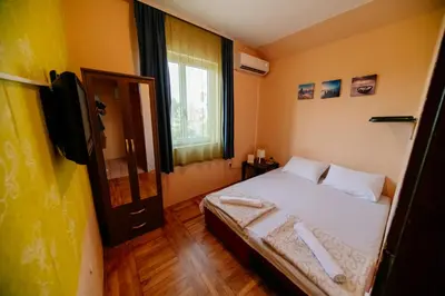 a small bedroom with a bed and a television at Explorer Podgorica in Podgorica