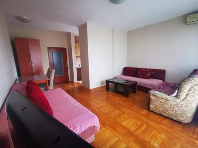 a living room with a couch and two chairs at Explorer Podgorica in Podgorica