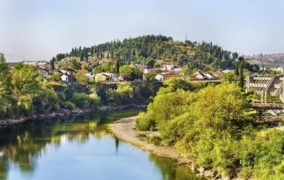 a river with a town in the background at Explorer Podgorica in Podgorica
