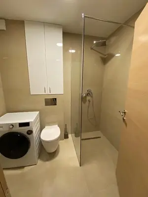 a bathroom with a toilet and a glass shower stall at Dream 1 apartment in Budva