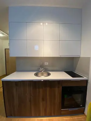 a kitchen counter with a sink and white cabinets at Dream 1 apartment in Budva