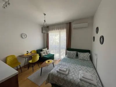 a bedroom with a bed and a living room at Dream 1 apartment in Budva