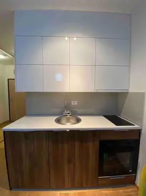 a kitchen counter with a sink and white cabinets at Dream 1 apartment in Budva