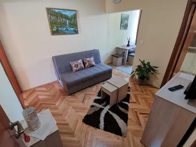 a living room with a couch and a table at Apartments Abramovic in Sutomore