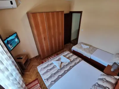 an overhead view of a bedroom with two beds and a television at Apartments Abramovic in Sutomore