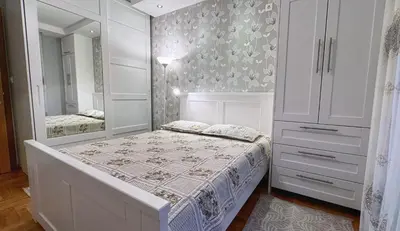 a white bedroom with a bed and a mirror at Incanto Adriatiko in Bar