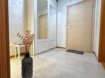 a hallway with a black vase with a plant in it at Incanto Adriatiko in Bar