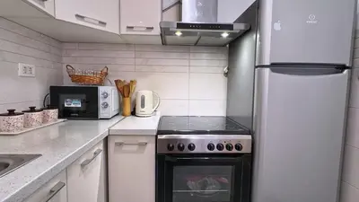a kitchen with a stove and a refrigerator at Incanto Adriatiko in Bar