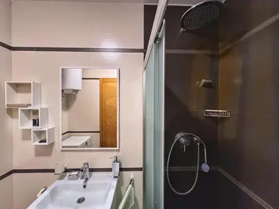 a bathroom with a sink and a shower and a mirror at Incanto Adriatiko in Bar