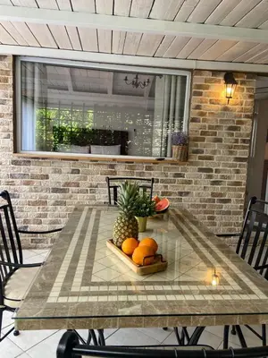 a table with fruit on it on a patio at Apartments Bajkovic in Kotor