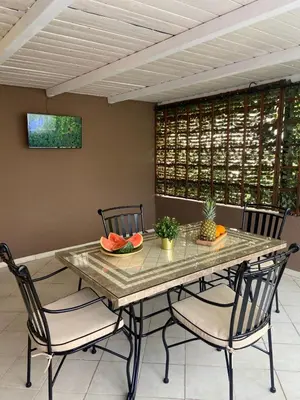 a dining room with a table with chairs and fruit on it at Apartments Bajkovic in Kotor