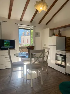 a kitchen and dining room with a table and chairs at Apartments Bajkovic in Kotor