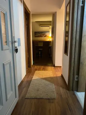 a hallway with a door leading to a room with a table at Apartments Bajkovic in Kotor