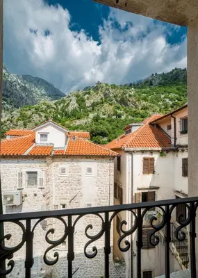 a view from a balcony of buildings and mountains at Kerber-Graz 1860 in Kotor