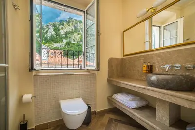 a bathroom with a sink and a window at Kerber-Graz 1860 in Kotor