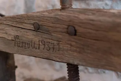 a wooden bench with writing on the back of it at Kerber-Graz 1860 in Kotor